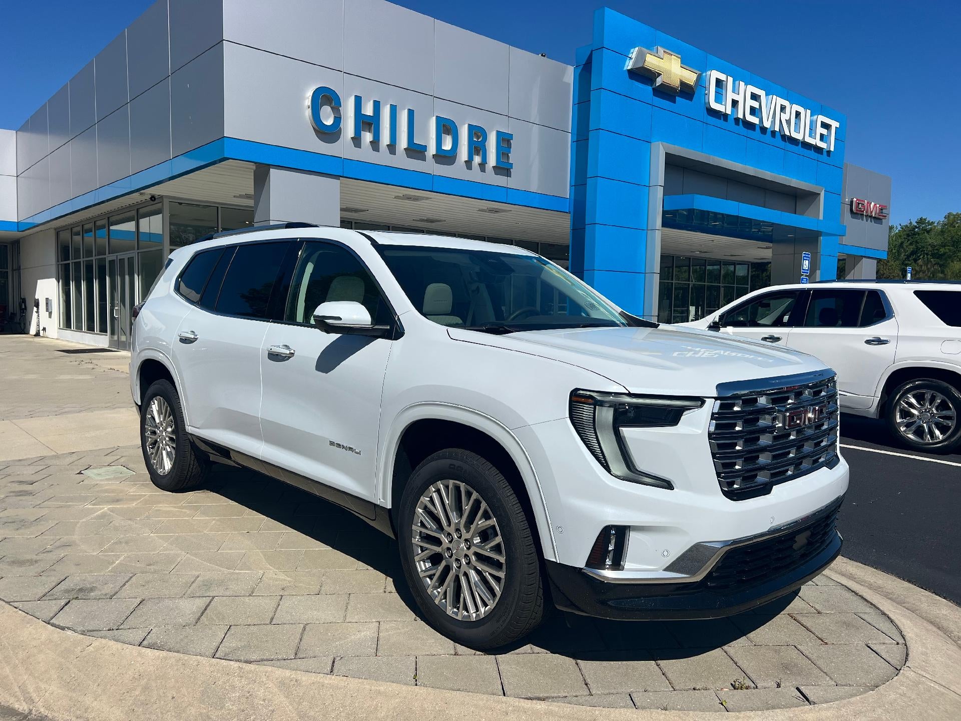 2026 GMC Acadia Denali in Glacier White Tricoat — front three-quarter view