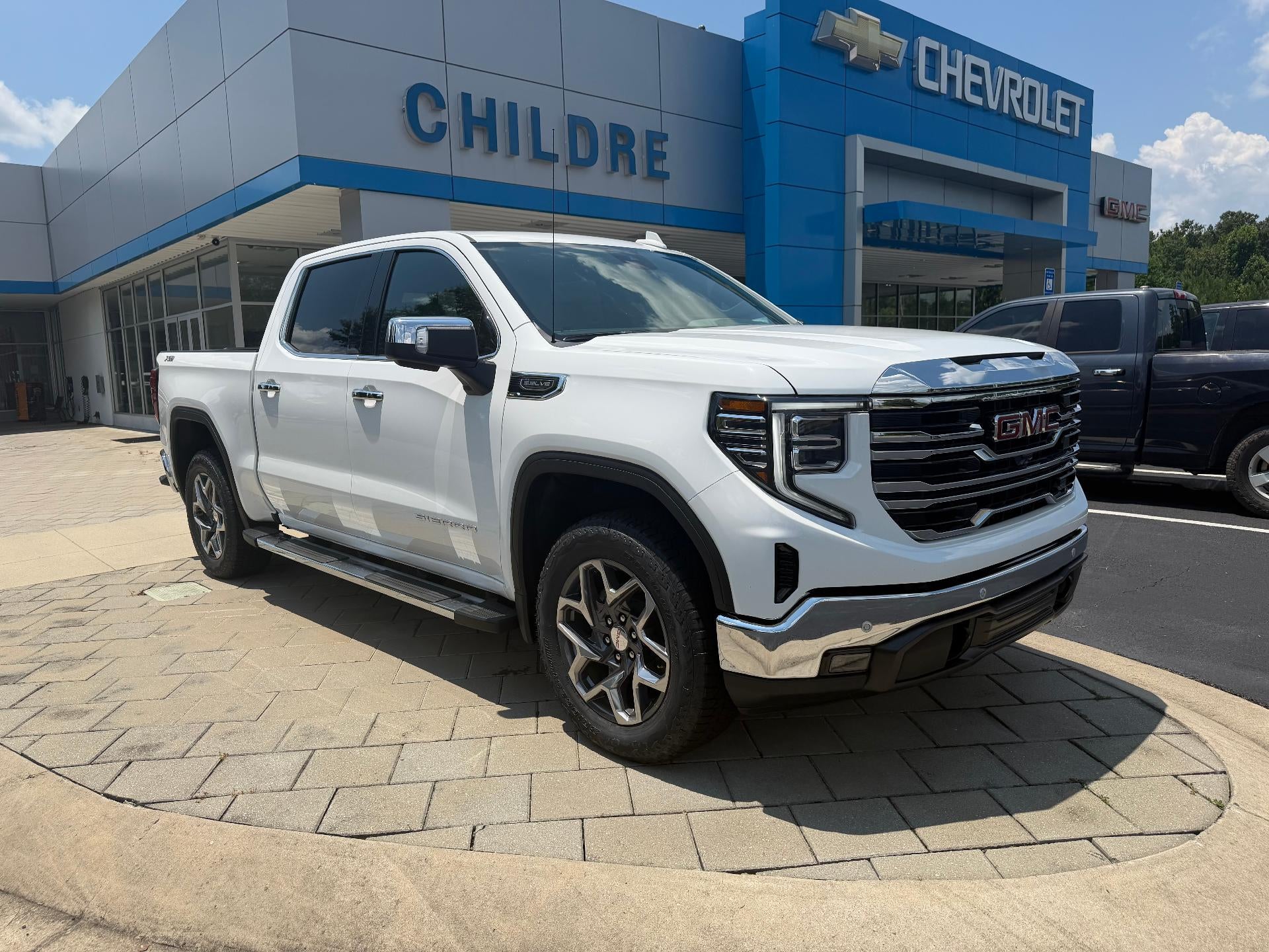 2026 GMC Sierra 1500 SLT in Summit White — front three-quarter view