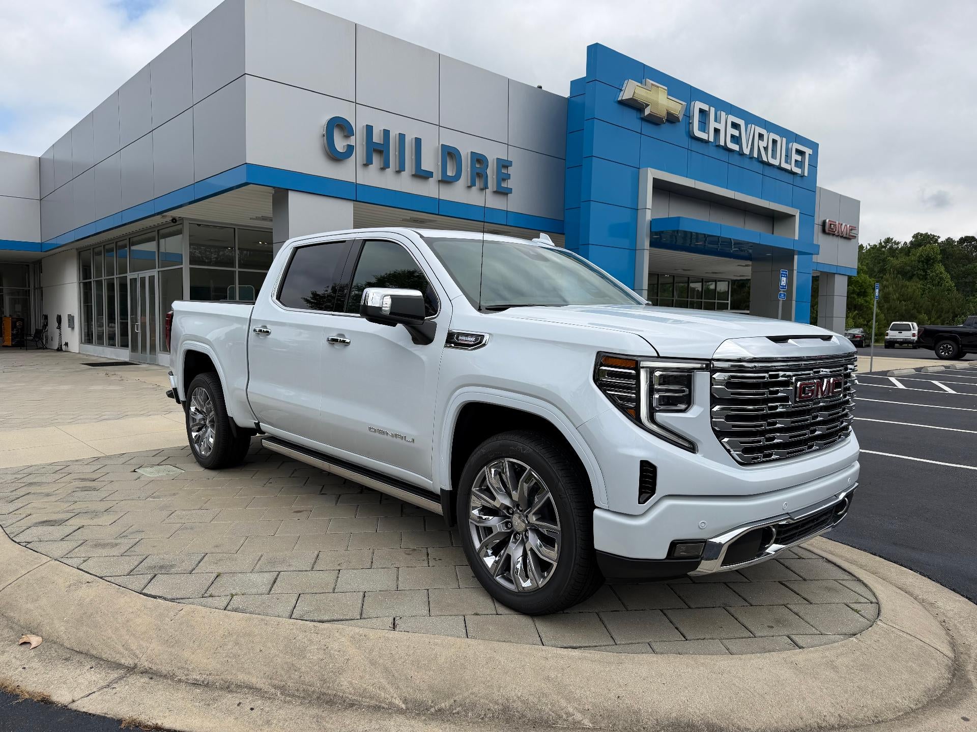 2026 GMC Sierra 1500 Denali in Glacier White Tricoat — front three-quarter view